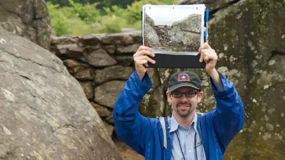 Photo of Gary Adelman holding up an image